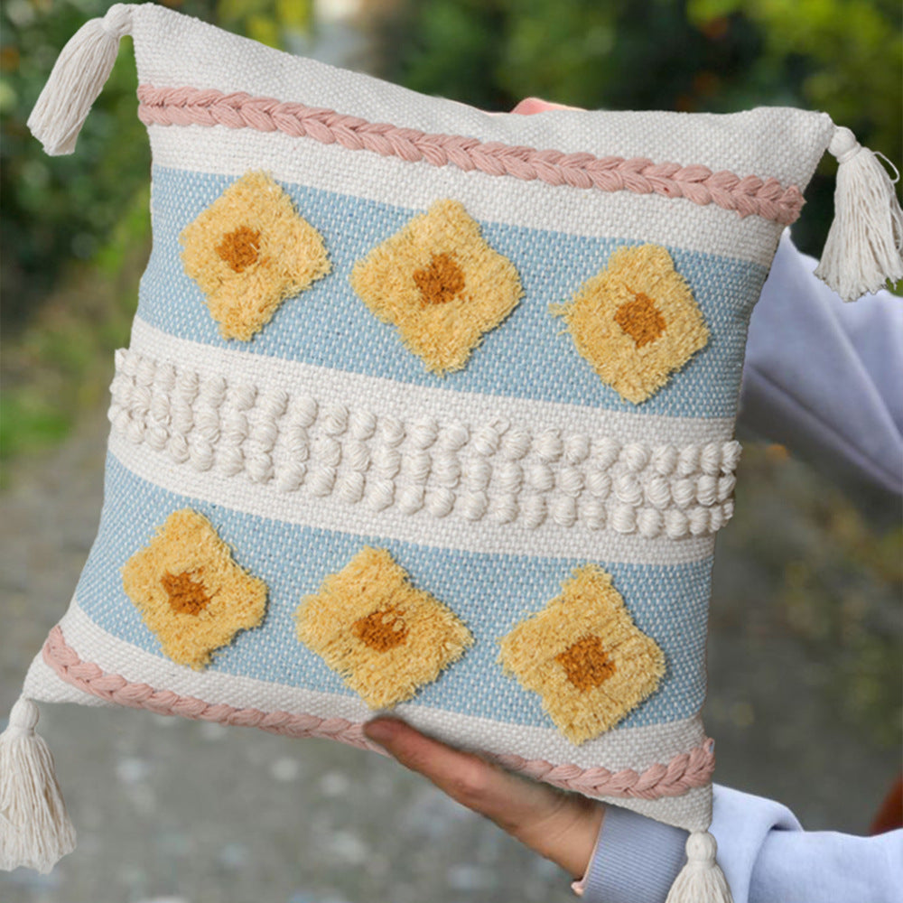 Structured decorative pillow with tufted diamonds, relief border, and corner tassels