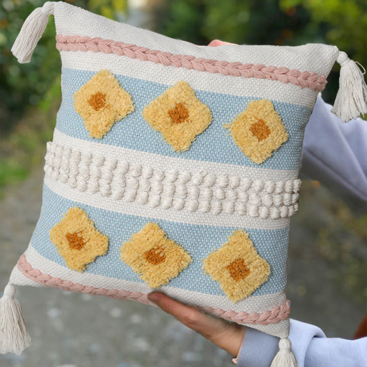 Structured decorative pillow with tufted diamonds, relief border, and corner tassels