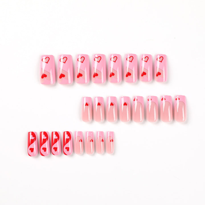 Artificial nail art with heart design and glitter accents Stornfield