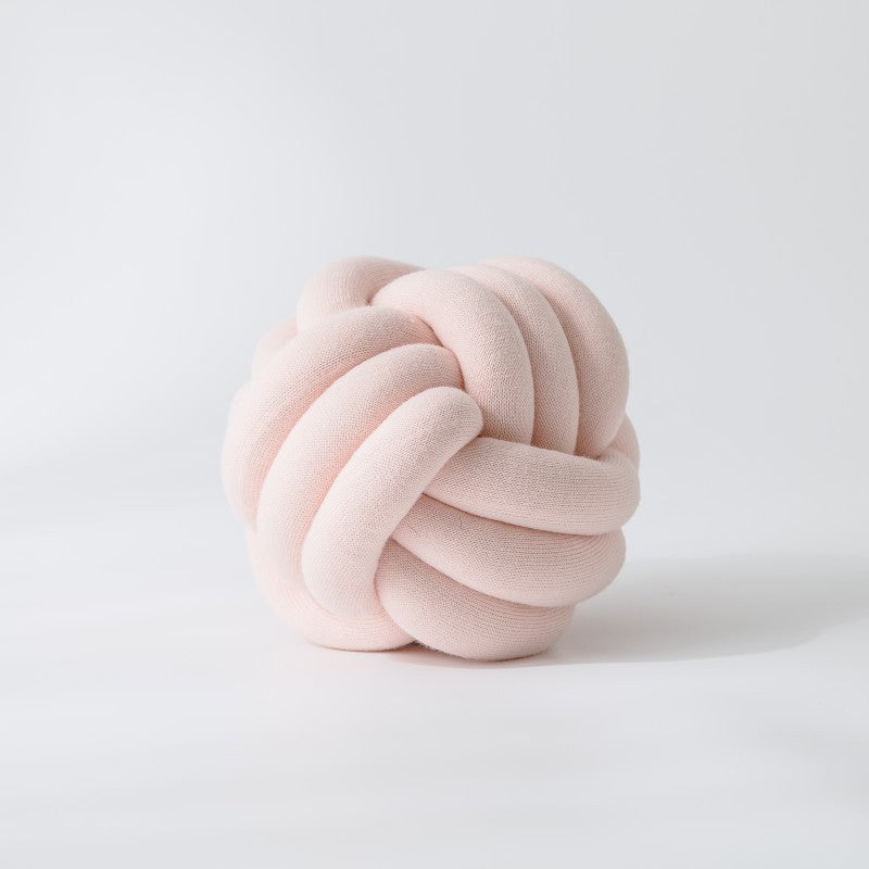 Decorative knitted knot cushion as a decorative pillow made of soft jersey