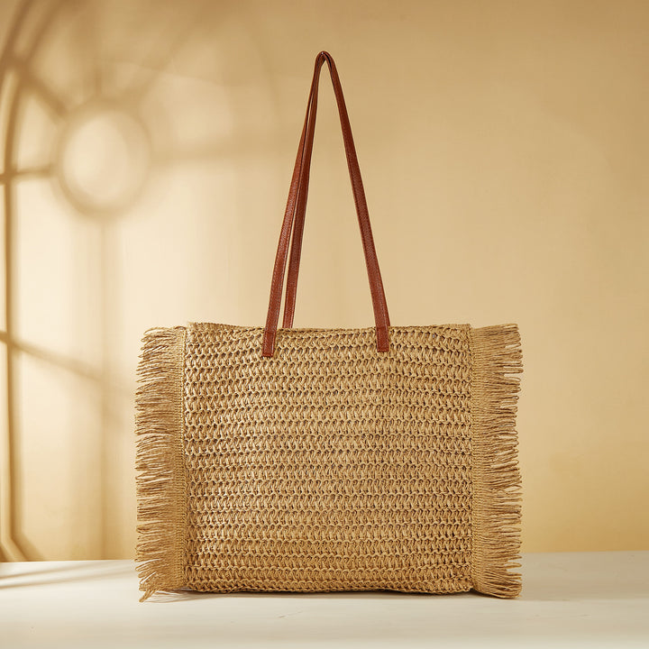 Beach bag made of raffia with fringed details Stornfield