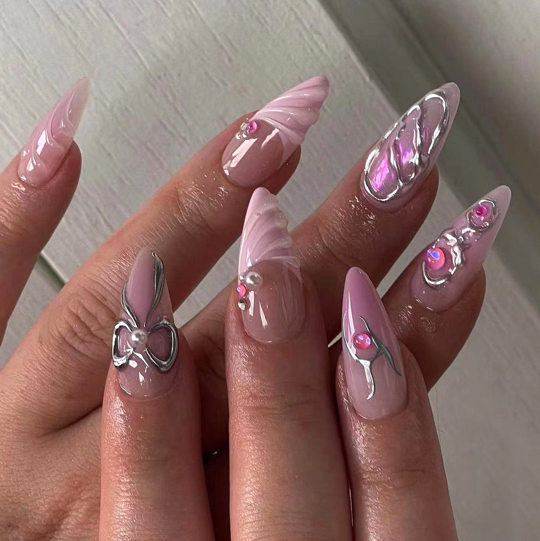 Artful stiletto nails with glitter and pearl decorations Stornfield