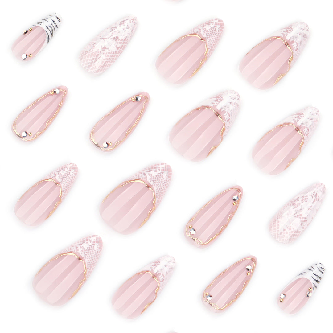 Artful stiletto nails with gold and tip embellishments Stornfield