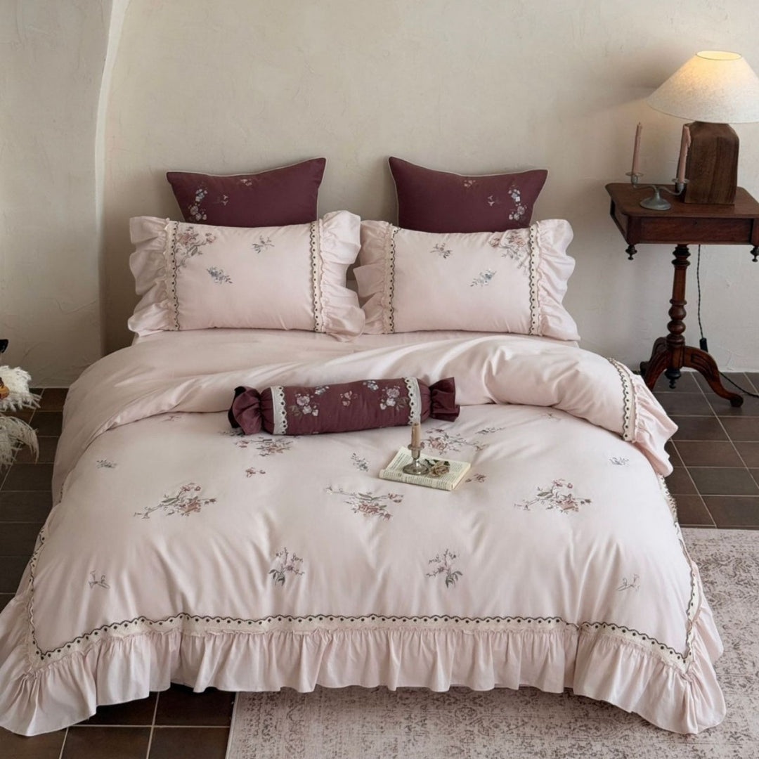 Romantic bedding set with ruffle, floral embroidery and decorative roll