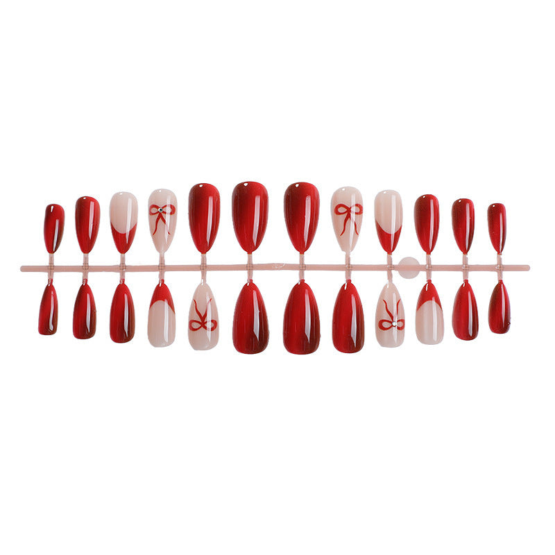 Glamorous artificial nail set with glitter effects and elegant bow motifs Stornfield