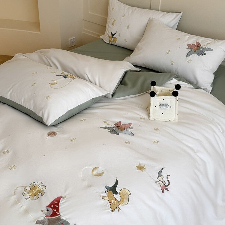 Children's bedding set with embroidered fairy tale forest motifs and reversible option