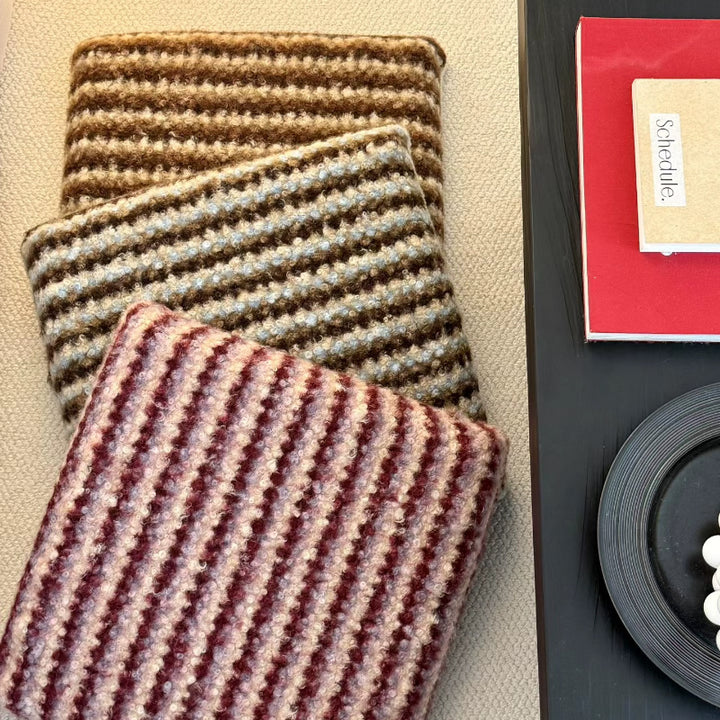 Knitted decorative cushion with wool blend and retro stripe texture