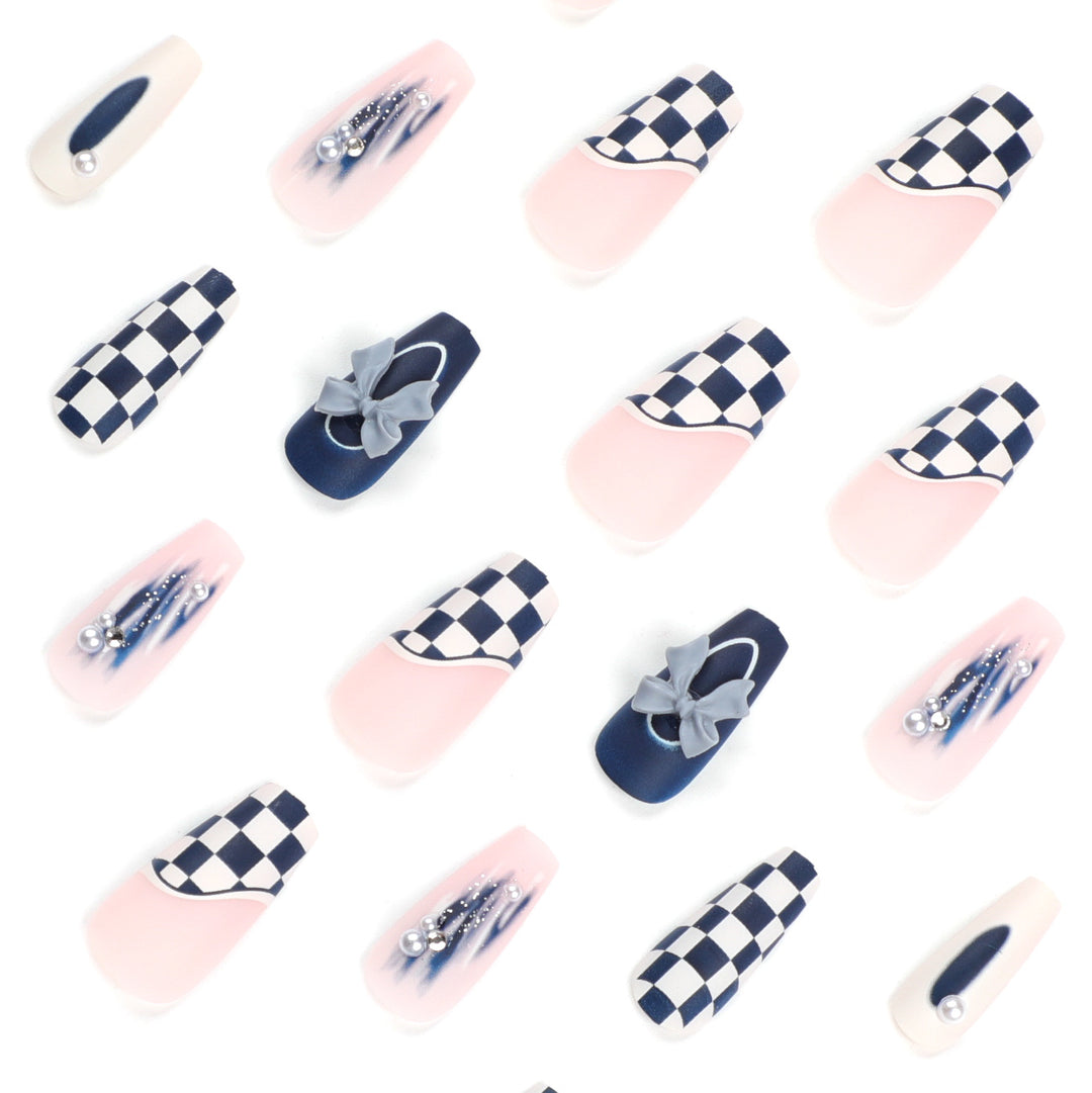 Artful nail decoration with bows and plaid pattern Stornfield
