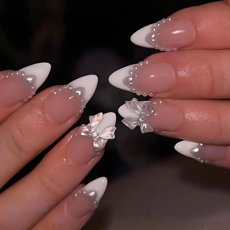 Artificial nail set with elegant tips and playful bow details Stornfield