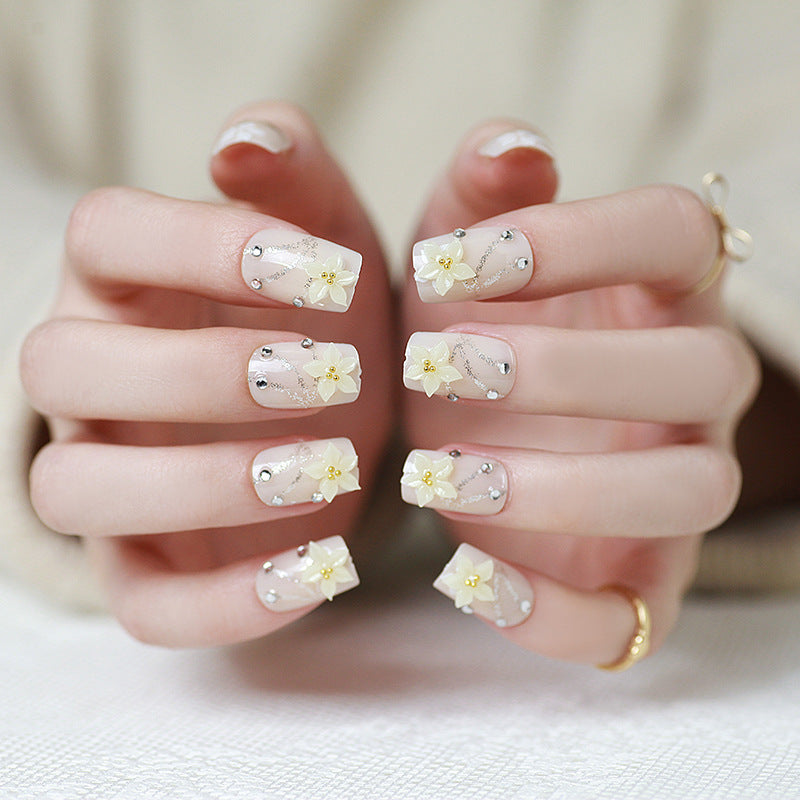 Artificials nails with sparkling rhinestone accents and elegant flower embellishments Stornfield