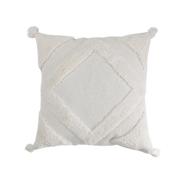 Square decorative cushion cover made of cotton bouclé with raised diamond pattern and corner tassels
