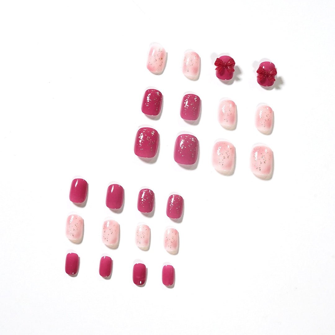 Artificial nail art with glitter embellishments and cute bow motif Stornfield