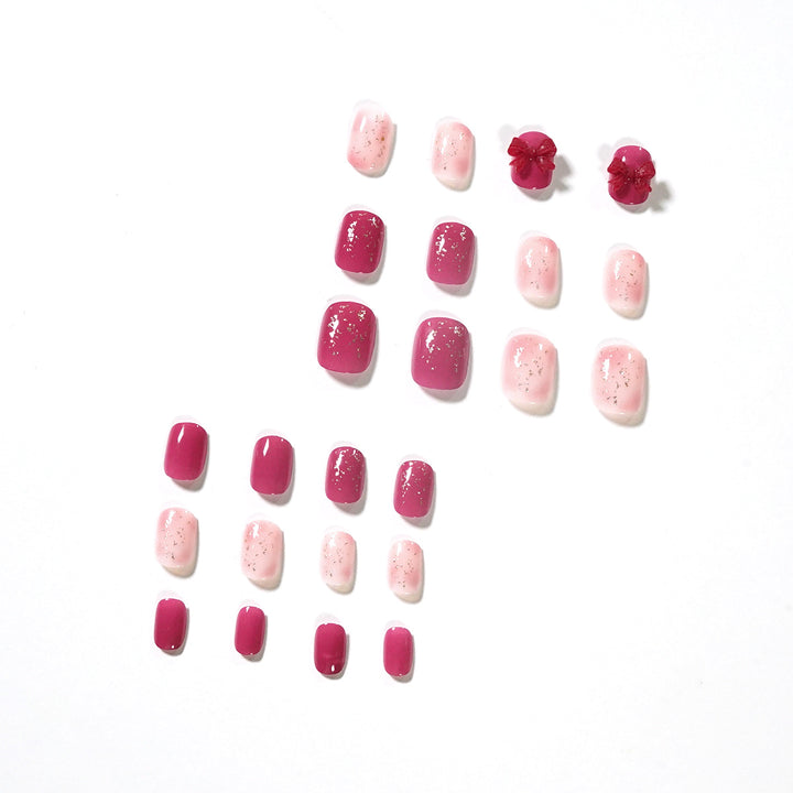 Artificial nail art with glitter embellishments and cute bow motif Stornfield