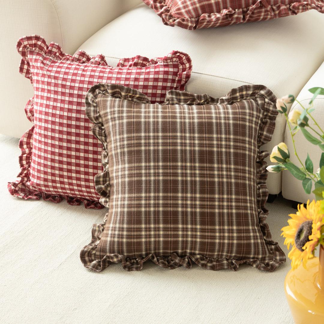 Decorative cushion with gingham pattern and playful ruffled edge