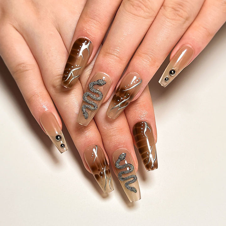 Artistic fingernails with snake and glitter accents Stornfield