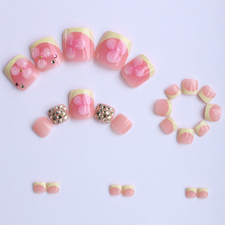 Artificial nail extensions with flower design and glitter accents Stornfield