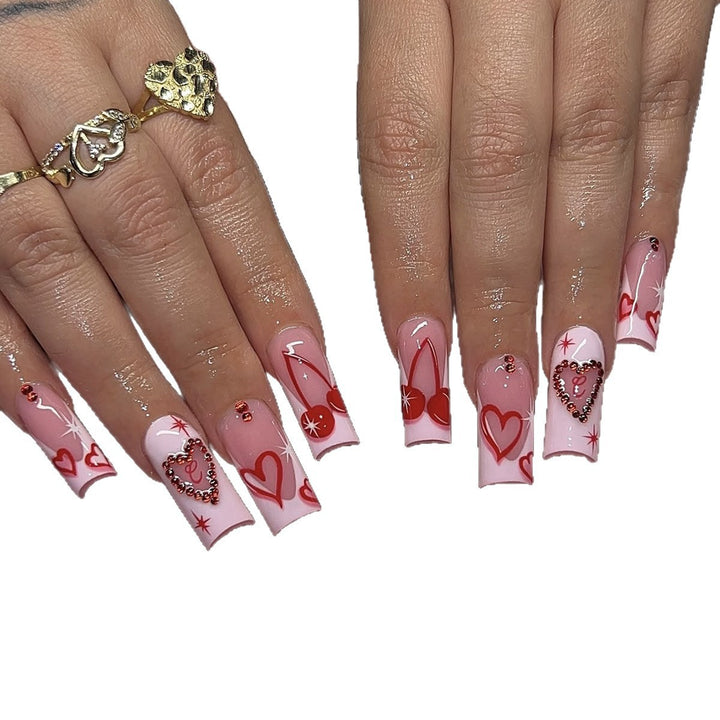 Artificial nail set with romantic heart designs and sparkling rhinestone decorations Stornfield