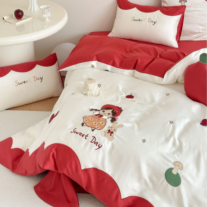Bedding set with embroidered doll and apple motifs