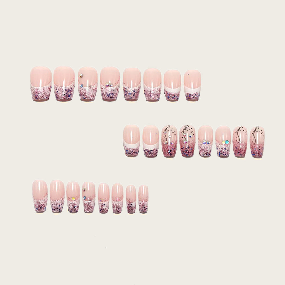 Glamorous artificial nails with glitter and rhinestone embellishments Stornfield