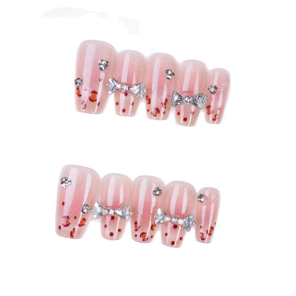 Art nails with delicate rhinestone and bow accents Stornfield