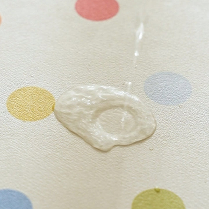 Oval wipeable placemat with pastel-colored polka dots Stornfield