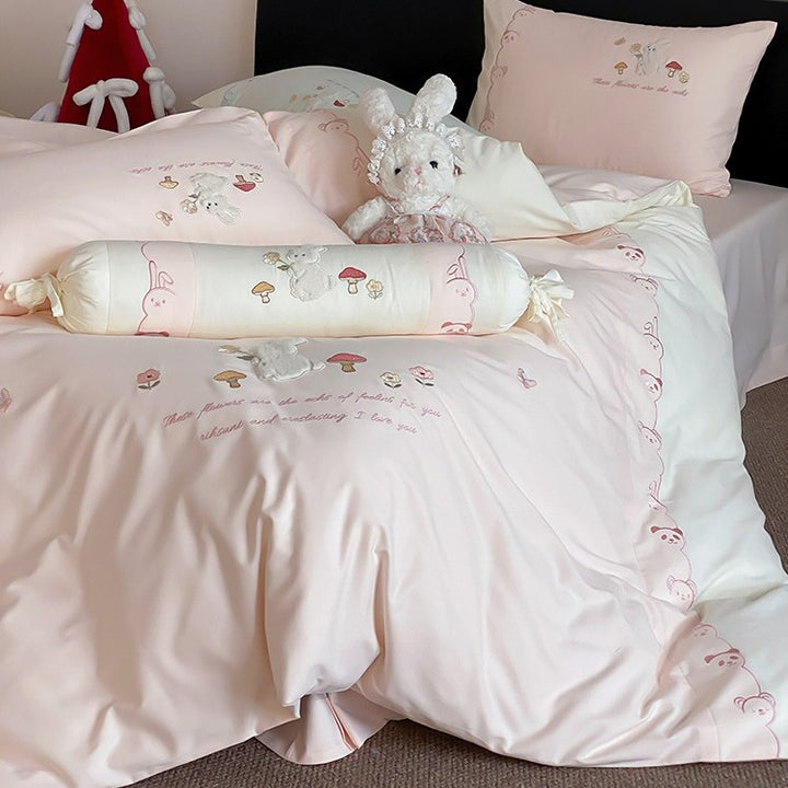 Playful cotton bedding set with plush bunny appliqué and round cushion