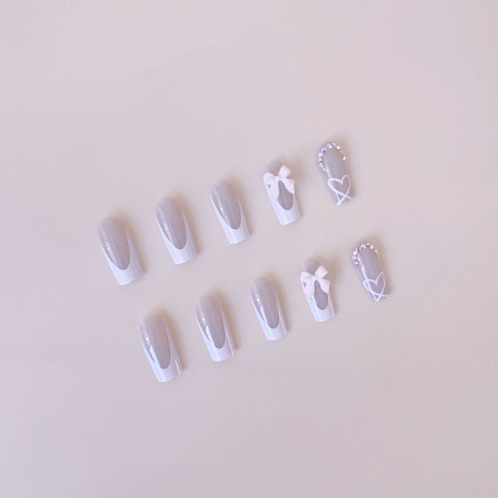 Artificial nail set with elegant bow and glitter decorations Stornfield