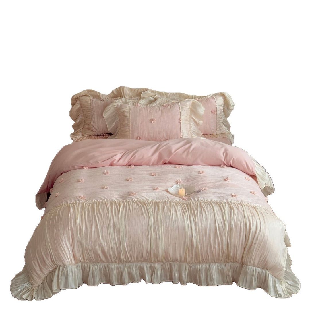 Satin look quilted bedspread with pleated ruffle and 3D flower appliqué