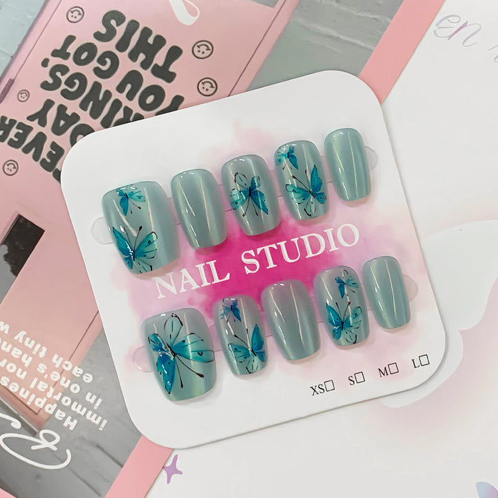 Artistic acrylic nails with butterfly motif Stornfield