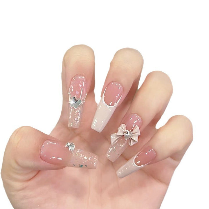 Artificial nails with glitter accents and playful motifs Stornfield