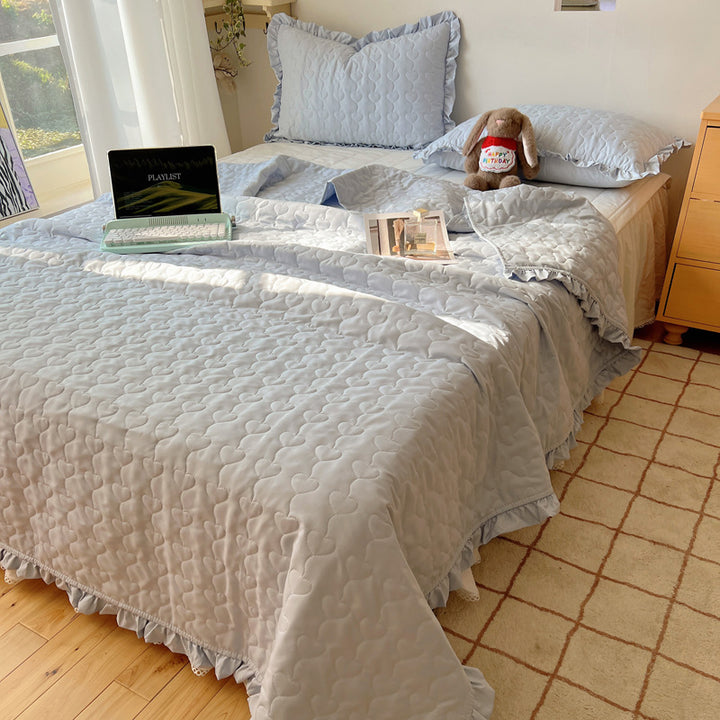 Quilted bedspread set with frill edge and heart quilting pattern