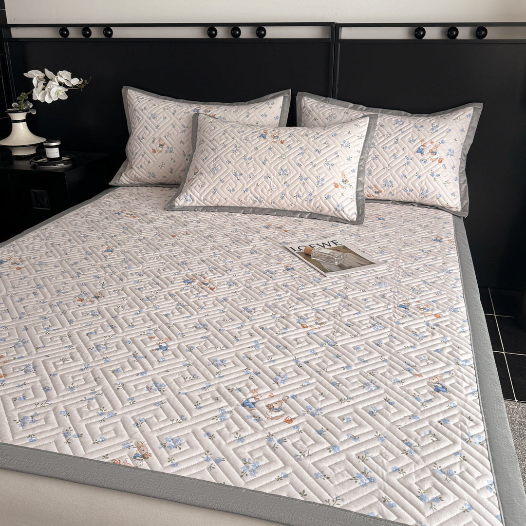 Quilted bedspread and pillow set with geometric striped quilting