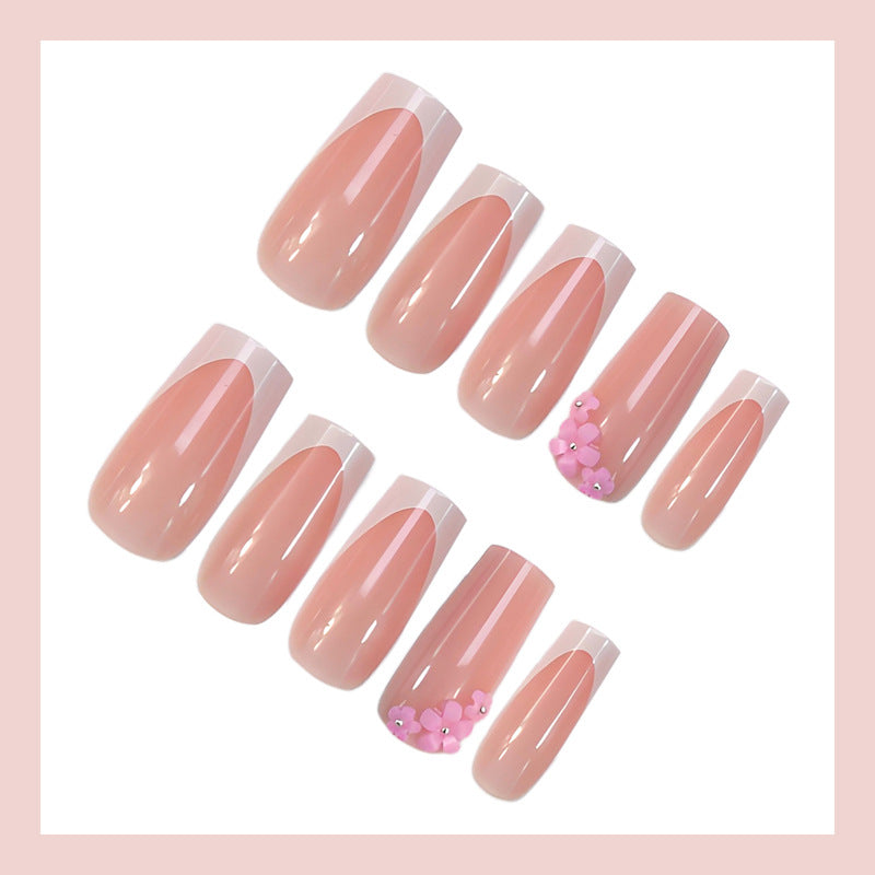 Acrylic nail set with elegant French tips and decorative accents Stornfield
