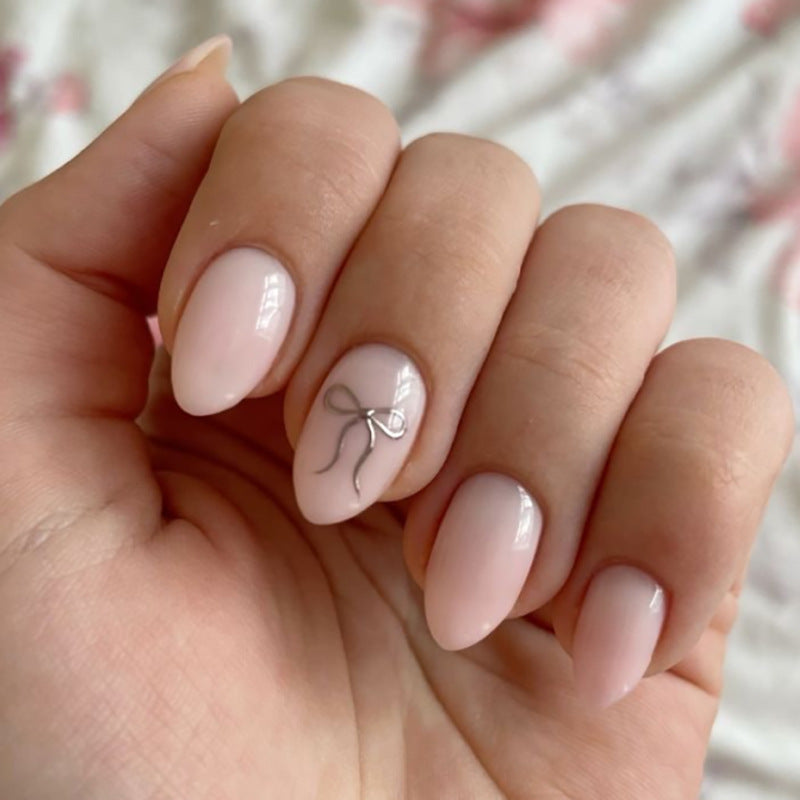 Artificial nail art with playful dots and bows Stornfield