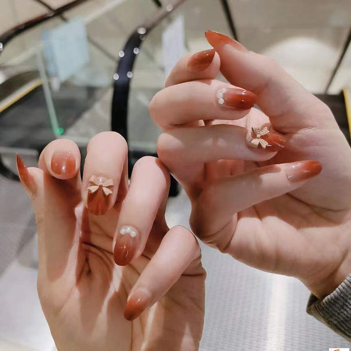 Artificial nails with glamorous bow and pearl decor Stornfield
