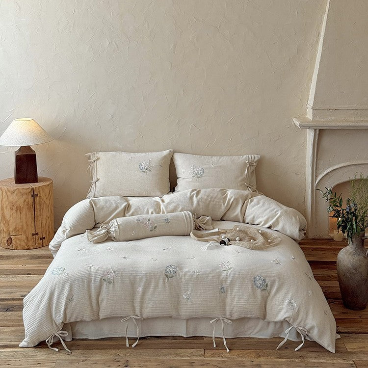 Embroidered cotton-linen bedding set with decorative ribbons and fine floral design