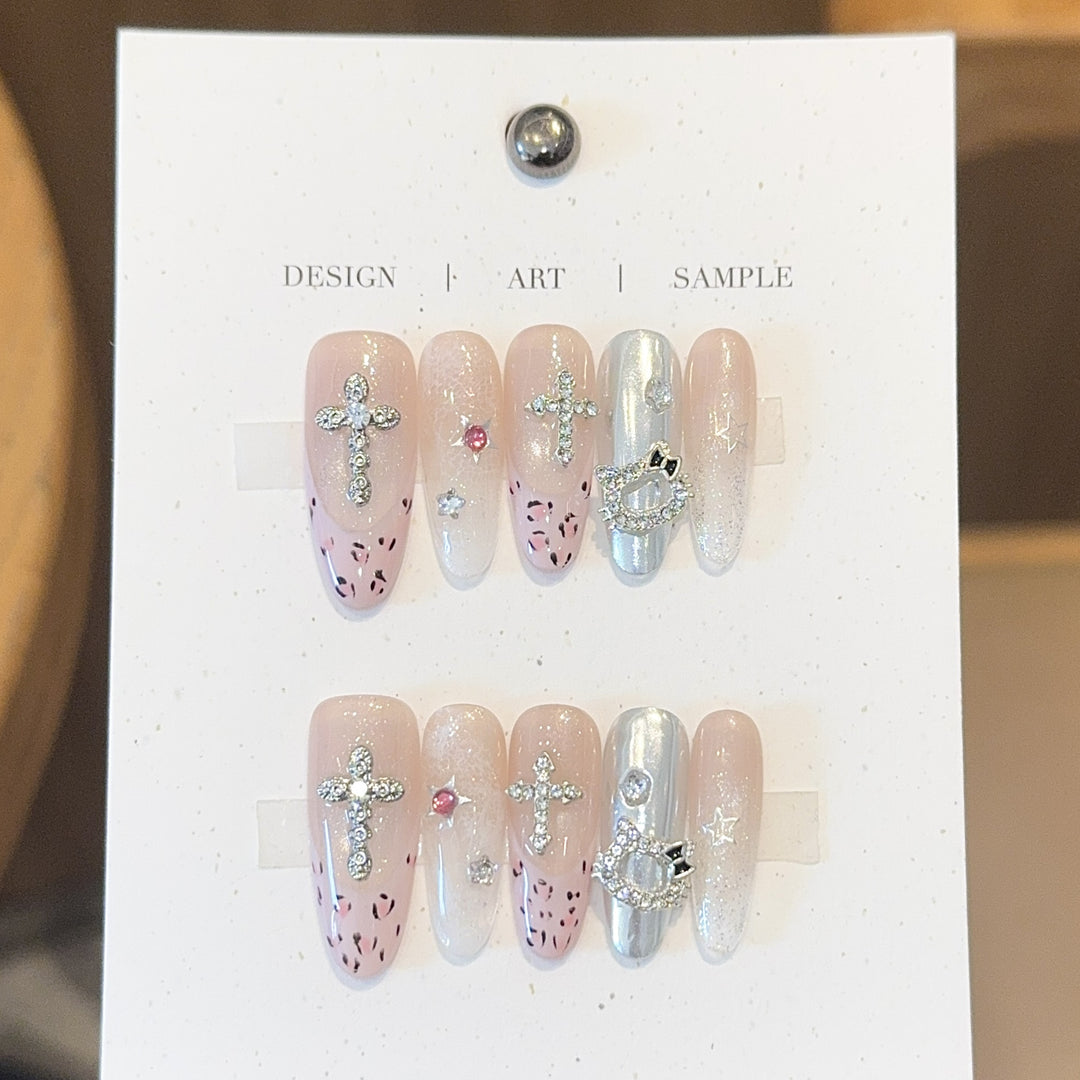 Artificial nails with sparkling rhinestones and cross motifs Stornfield
