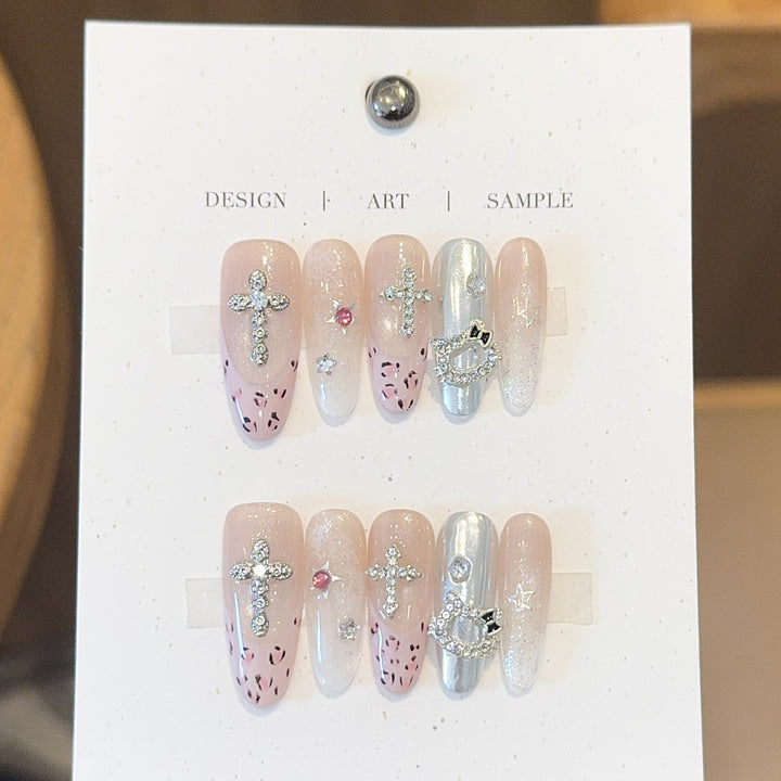 Artificial nails with sparkling rhinestones and cross motifs Stornfield