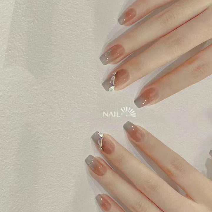 Artificial nail set with elegant ombre design and sparkling applications Stornfield