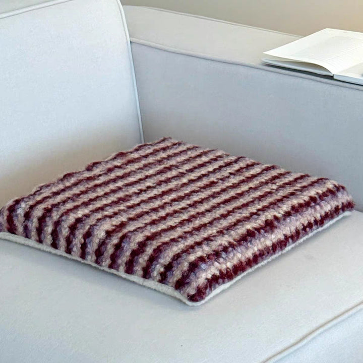 Knitted decorative cushion with wool blend and retro stripe texture