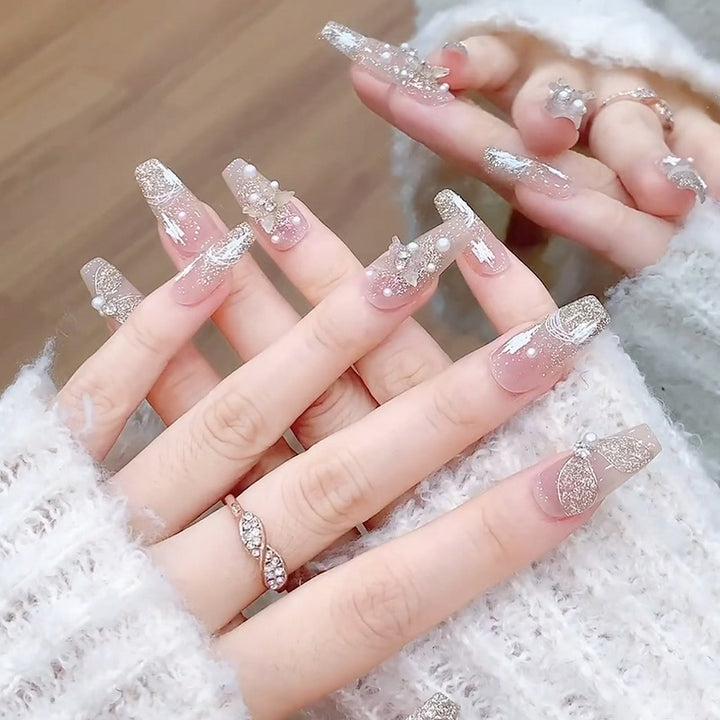 Glamorous artificial nails with heart-shaped accents Stornfield