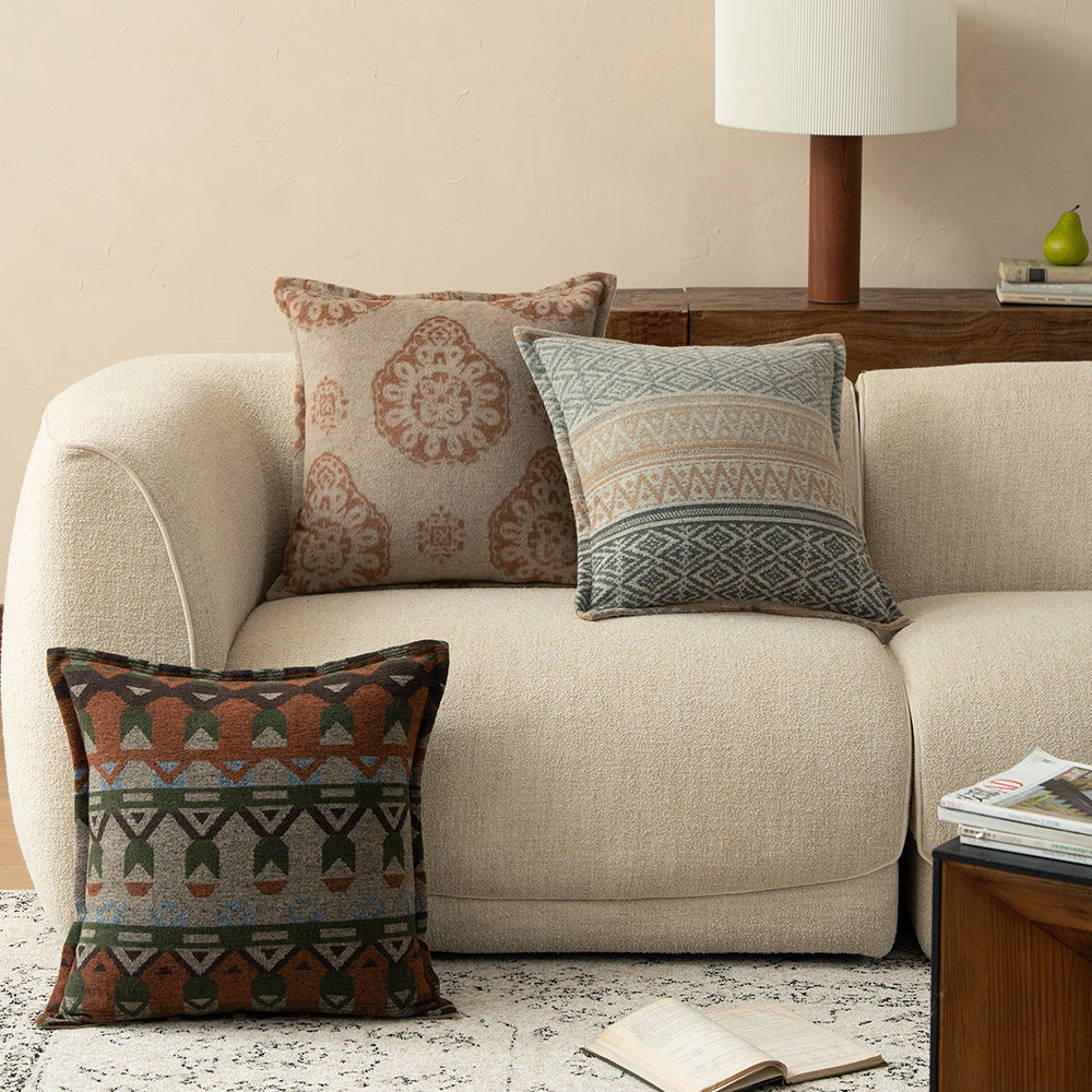 Square decorative sofa cushion with jacquard-woven ornament and soft bouclé surface Stornfield