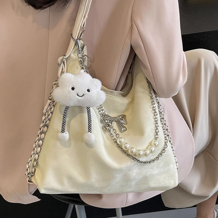 Fashionable handbag with unique pendant and chain accents Stornfield