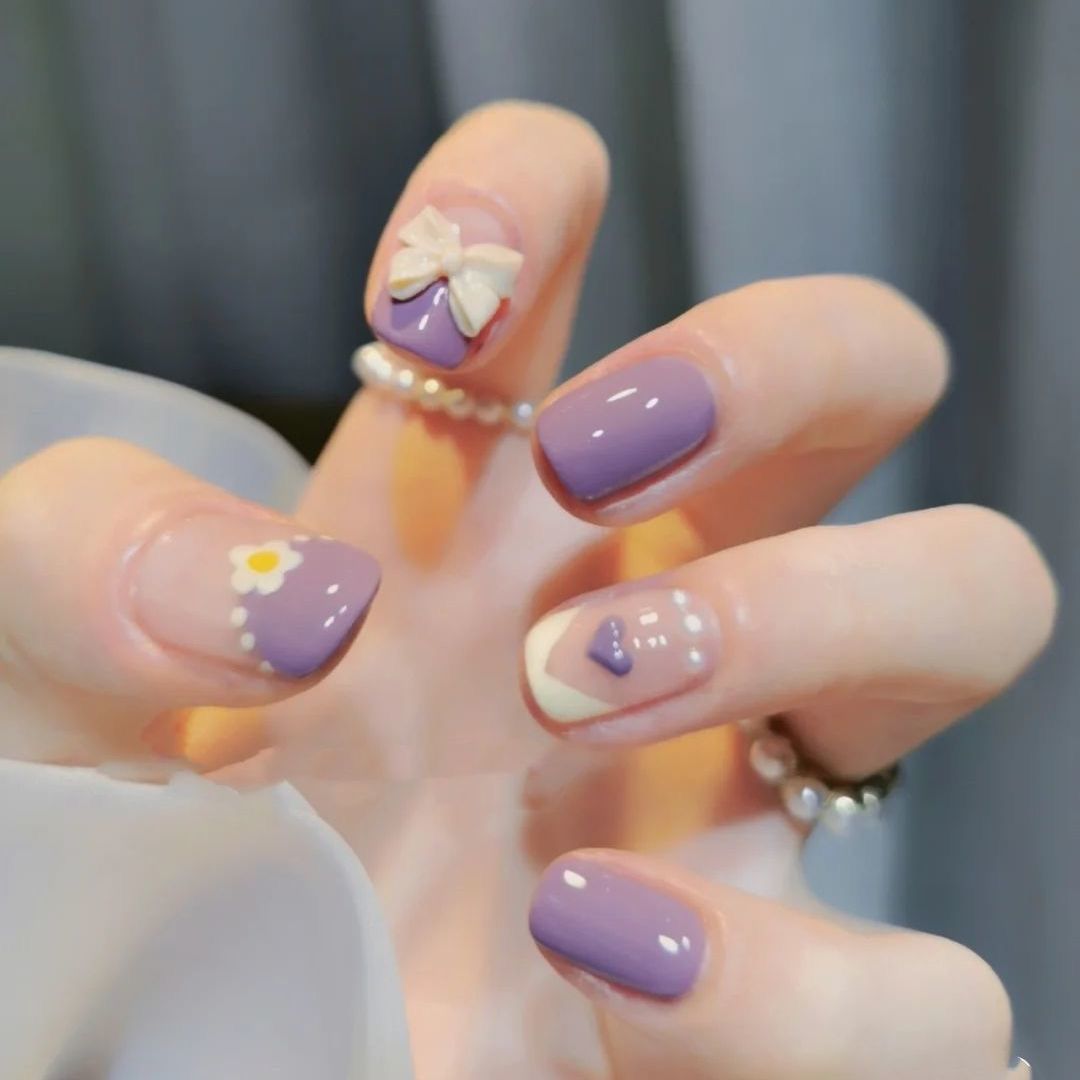 Glamorous artificial nails with heart design and glittering accents Stornfield