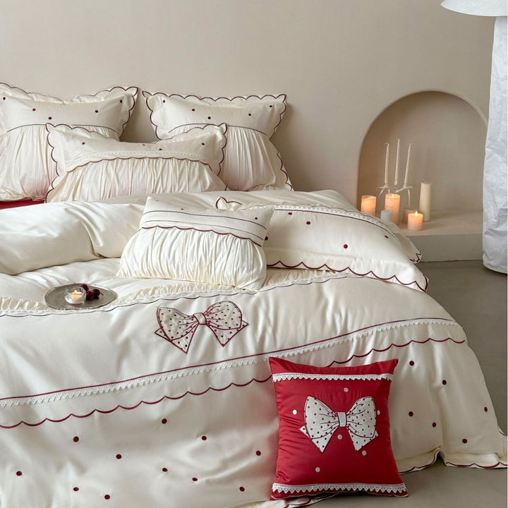 Elegant cotton satin bedding set with decorative bow appliqué and gathered frill