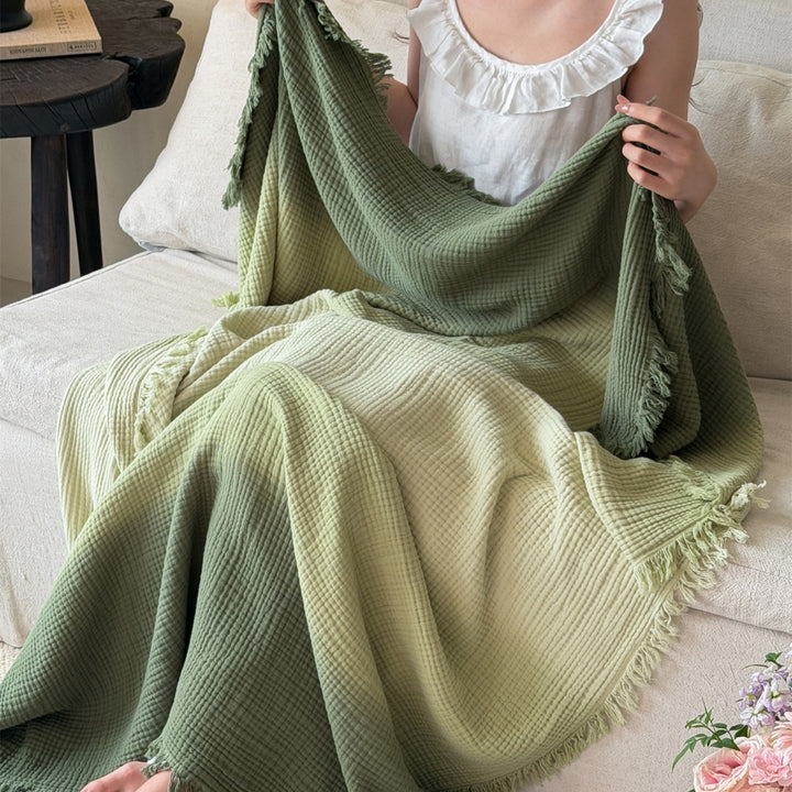 Large waffle blanket with ombre coloring and decorative fringes