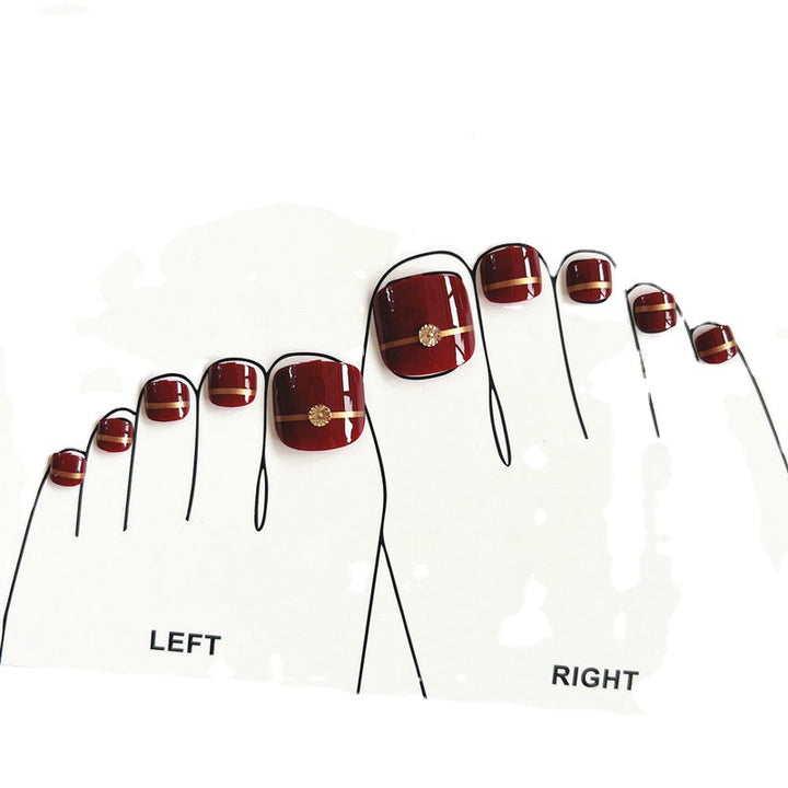 Artificial toenails with elegant gold embellishments Stornfield