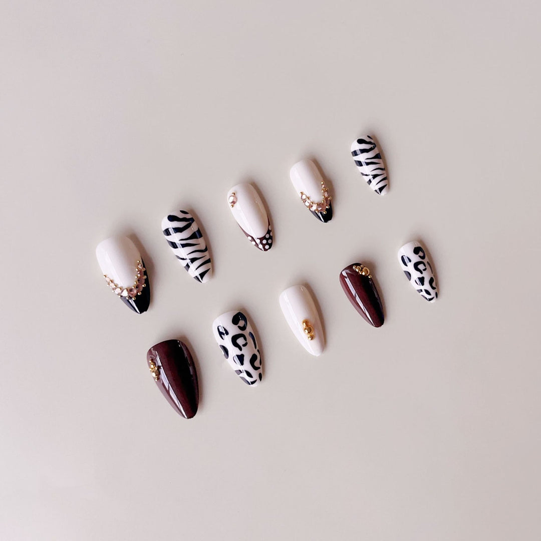 Acrylic nail set with luxurious animal motif designs and glamorous accents Stornfield