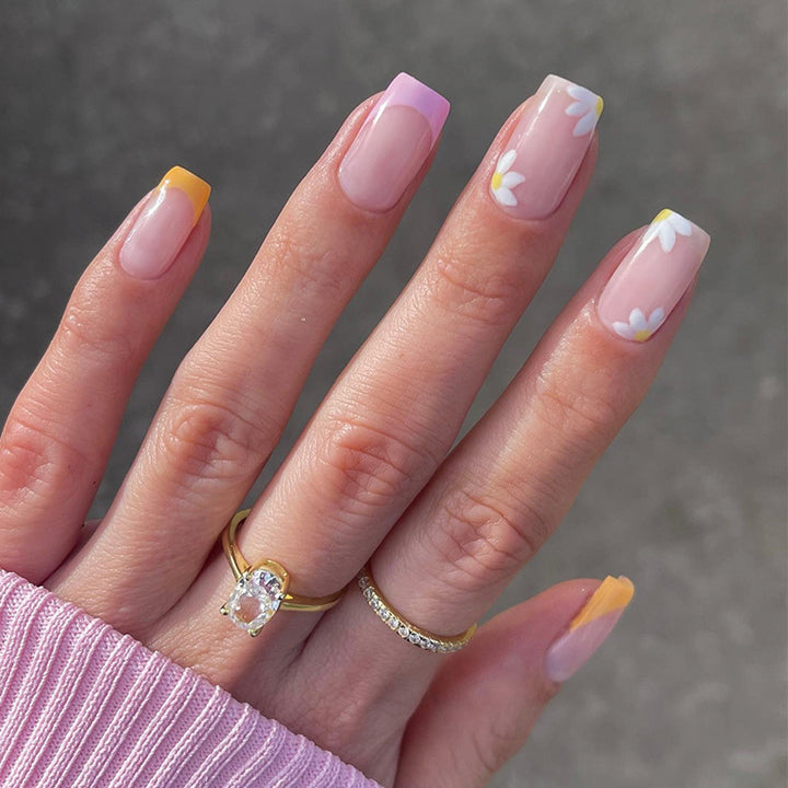 Artistic acrylic nails with floral design and creative color accents Stornfield