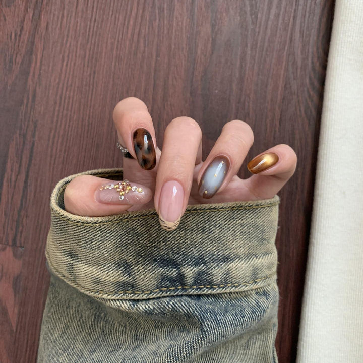 Artificial nail set with elegant patterns and glitter accents Stornfield